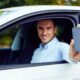 A driver with a phone in his hands