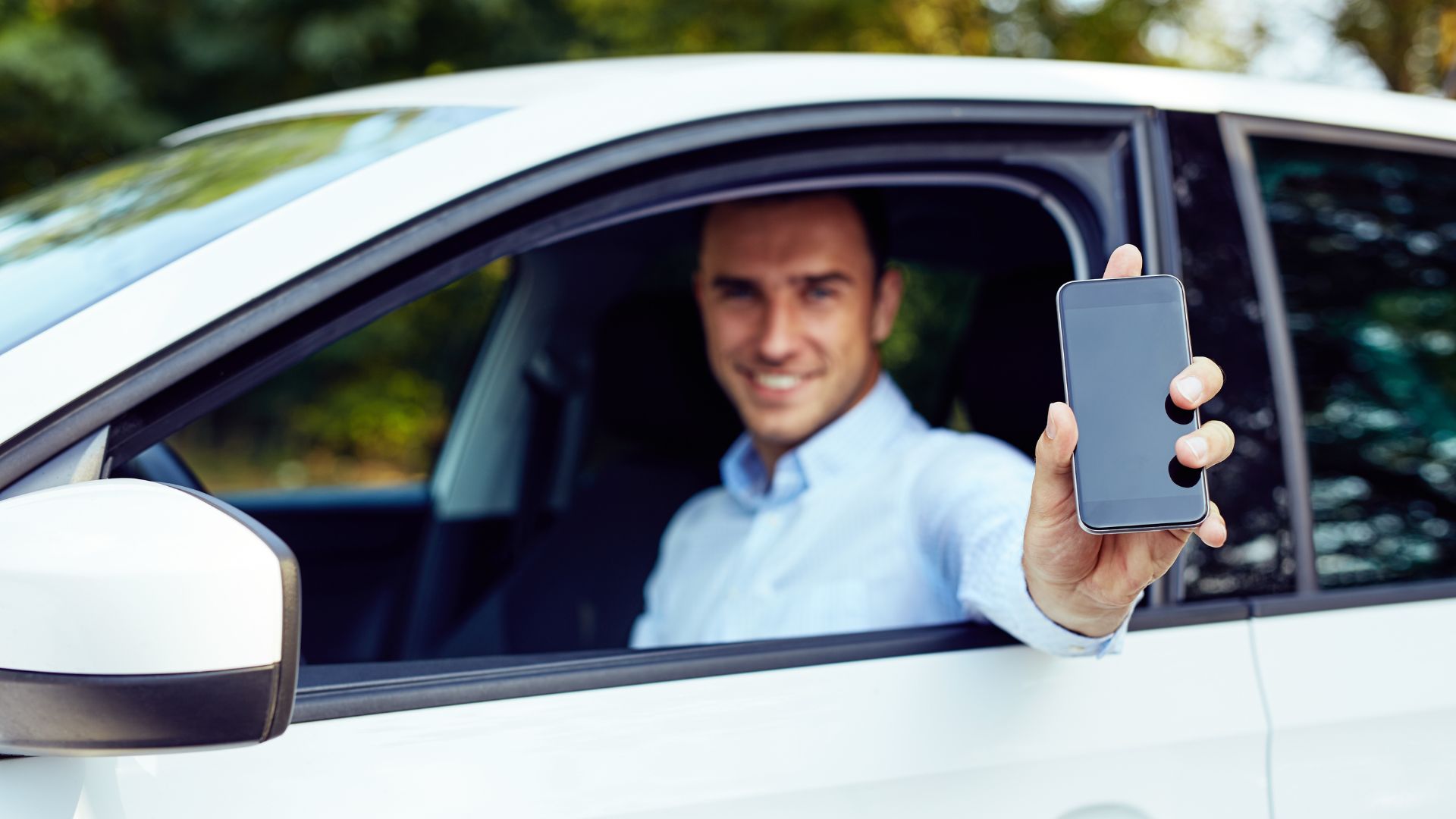 A driver with a phone in his hands
